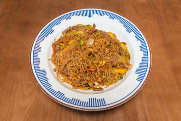 Triple-texture noodles: soft udon, al dente vegetables, and pork cracklings, topped with spun quail egg.