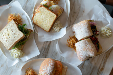 Assorted sandwiches served on a cozy cafe table