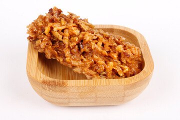 Brazilian brown cocada, coconut candy, a traditional homemade treat very common in Brazil. Isolated on a white background