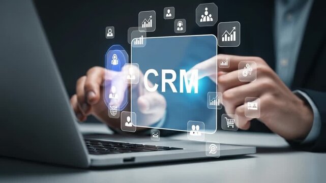 A person interacting with a crm interface on a laptop with various business icons around it