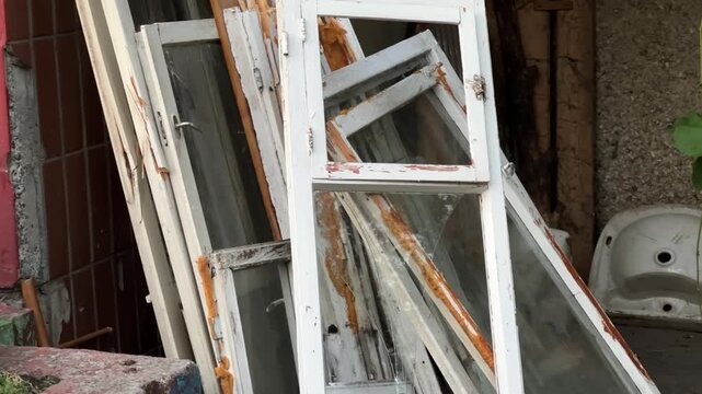 Old Wooden Window Frames Disposal After Home Renovation and Modern Plastic Windows Installation