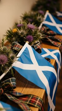 Scottish flags, thistles, and tartan ribbon decorations. A patriotic display of Scotland's national symbols, the Saltire and thistle flower, for a celebration.