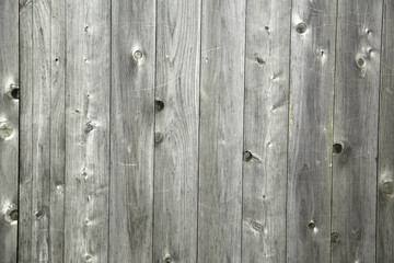 Close-up of old wooden planks with natural knots and weathered texture.