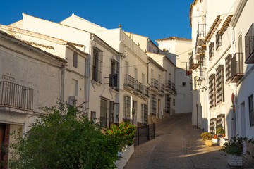 Fototapeta premium White village of Zahara de la Sierra at sunset with the church and the castle in the Cadiz province of Spain.