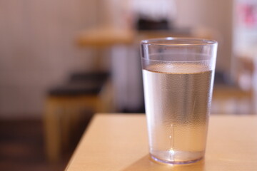 glass of water on wooden table of cafe shop

