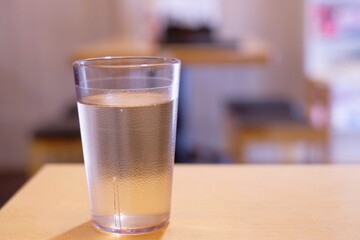 glass of water on wooden table of cafe shop
