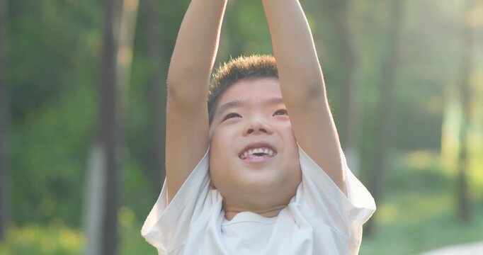 Chinese children smiling in the park.