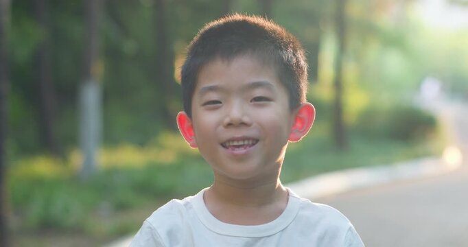 Chinese children smiling in the park.