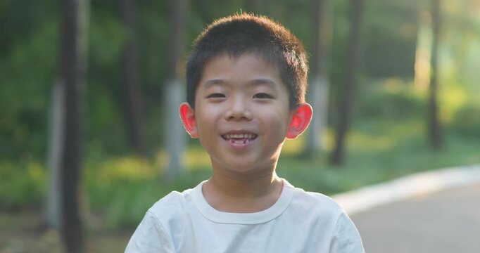 Chinese children smiling in the park.