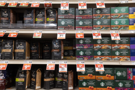 Davis, CA, USA. 11 August 2025. Supermarket store shelf with various brands of coffee, with price tags underneath of them
