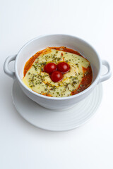 Gourmet 'Quesaña,' a creative no-pasta lasagna made with layers of melted cheese instead of pasta, a healthy low-carb and keto-friendly baked dish with tomato sauce, isolated on a white background