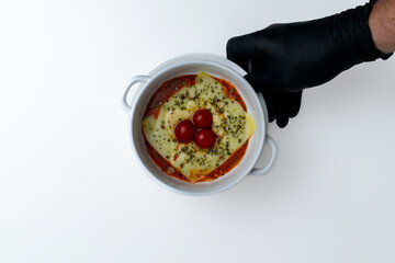 Gourmet 'Quesaña,' a creative no-pasta lasagna made with layers of melted cheese instead of pasta, a healthy low-carb and keto-friendly baked dish with tomato sauce, isolated on a white background