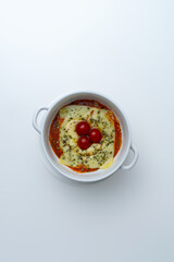 Gourmet 'Quesaña,' a creative no-pasta lasagna made with layers of melted cheese instead of pasta, a healthy low-carb and keto-friendly baked dish with tomato sauce, isolated on a white background