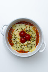 Gourmet 'Quesaña,' a creative no-pasta lasagna made with layers of melted cheese instead of pasta, a healthy low-carb and keto-friendly baked dish with tomato sauce, isolated on a white background