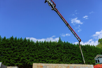 Obraz premium Construction site with concrete pump pouring for building foundation on works day