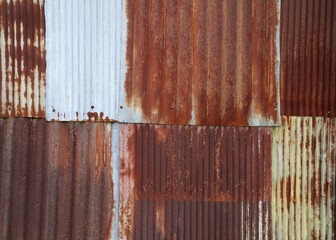 Artistic of old and rusty zinc sheet wall. Vintage style metal sheet roof texture. Pattern of old metal sheet. Rusting metal or siding. Corrosion of galvanized. Background and texture in retro concept