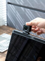 Cybersecurity Awareness Behaviors: sliding webcam cover on laptop