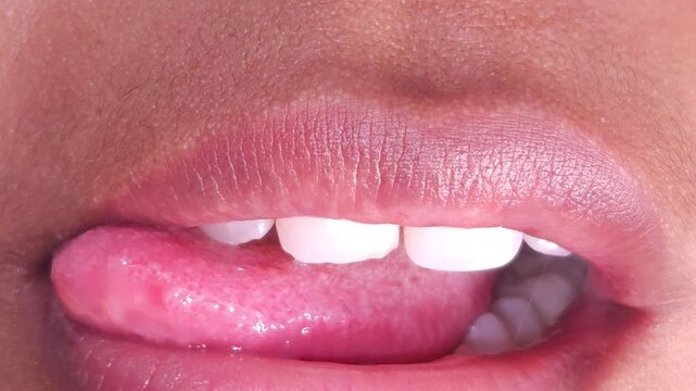 Close up Macro of Indian teenage girl lips doing various types of expressions. lift, Frown, grimace, moue, scowl, pout, Kiss, smooch, smack, peck, graze, caress, skim