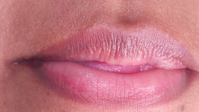 Close up Macro of Indian teenage girl lips doing various types of expressions. lift, Frown, grimace, moue, scowl, pout, Kiss, smooch, smack, peck, graze, caress, skim