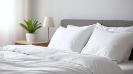 A serene bedroom scene featuring white bedding, soft pillows, and a potted plant, creating a calm and inviting atmosphere.