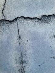 Cracked concrete wall with visible texture and damaged surface