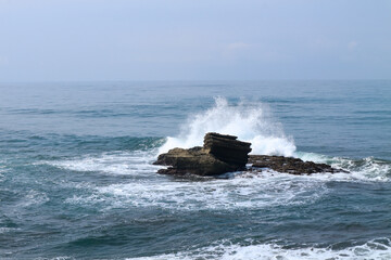 waves crashing against the rocks