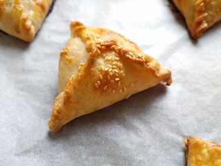 Close-up of a baking tray with homemade freshly baked samsa