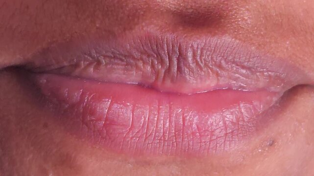 Close up Macro of Indian teenage girl lips doing various types of expressions. lift, Frown, grimace, moue, scowl, pout, Kiss, smooch, smack, peck, graze, caress, skim
