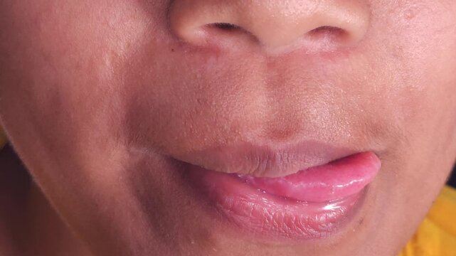 Close up Macro of Indian teenage girl lips doing various types of expressions. lift, Frown, grimace, moue, scowl, pout, Kiss, smooch, smack, peck, graze, caress, skim