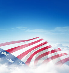 Obraz premium United States national flag waving in the clouds. The flag hiding in blue sky. American national flag for independence day. 4th july happy independence day of america.