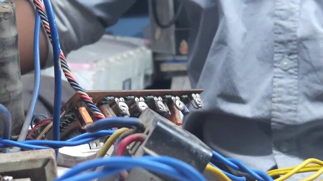 Electronics technician, electronic engineering electronic repair, electronics measuring and testing, repair and maintenance, mechanic working with parts in local shop in India, Odisha