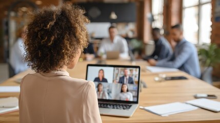 back view of business woman talking to her colleagues about plan in video conference multiethnic business team using laptop for a online meeting in video call group of people smart working from home