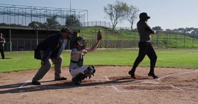 Reacting to umpire call male batter dropping bat and running toward first base at park diamond