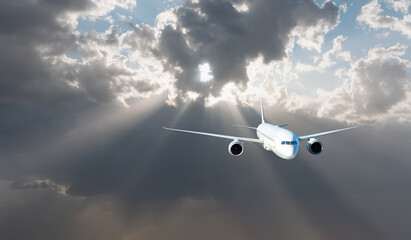 White passenger airplane flying in the sky amazing clouds in the background - Travel by air transport
