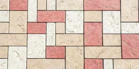 Mixed rectangular stone tiles in cream and coral pink arranged in random pattern with natural texture and weathered appearance.