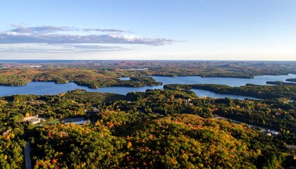 Panoramic autumn vista of interconnected lakes and colorful forests, seen from an elevated perspective