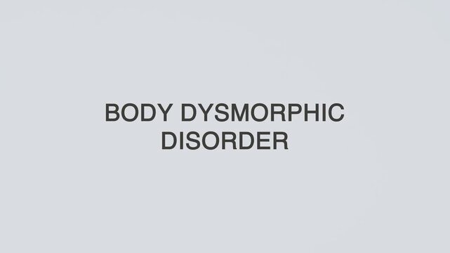 Body dysmorphic disorder word diagnosed with hand holding stethoscope on white background, symbolizing mental health awareness, diagnosis, and psychological condition.