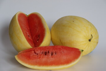 Vishala watermelon in whole, halved, and sliced styles, featuring smooth yellow rind and red flesh
