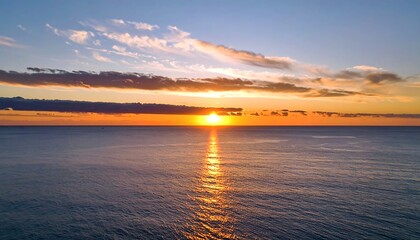 Wide shot of a beautiful sunrise or sunset over a calm ocean