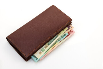 Afghan Afghani Banknotes in Brown Leather Wallet on White Background