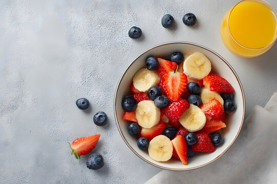 Healthy vibrant fruit salad with bananas, strawberries, and blueberries for breakfast - Powered by Adobe