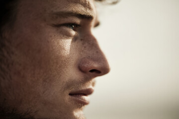 Obraz premium profile portrait of young man with flared nostrils captured during inhalation exuding sense of vitality