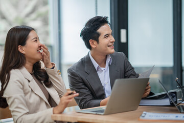 Group of Asian business people meeting and presenting work in the office