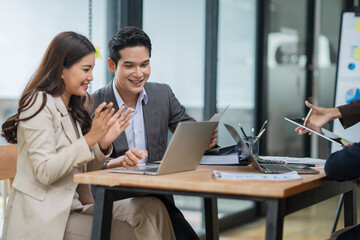 Group of Asian business people meeting and presenting work in the office