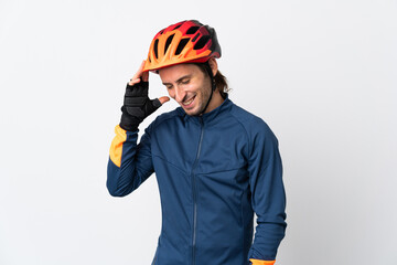 Young cyclist man isolated on white background laughing