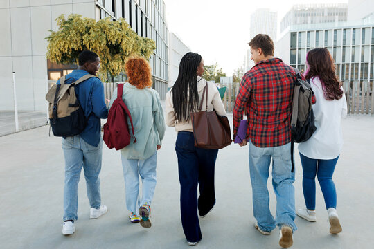 Diverse university or college students walking together on campus