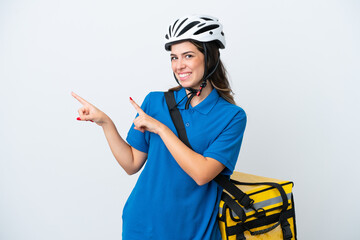 Young delivery woman with thermal backpack isolated on white background pointing finger to the side and presenting a product