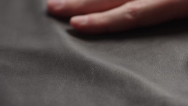 Slide shot man touching fine leather closeup