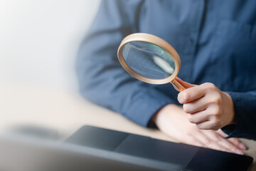 Fototapeta premium Using magnifying glass web search internet. Magnifier finance audit accounting. Magnifier analyzing research. Magnifying glass analyzing target audience marketing Woman job search website. Magnifying