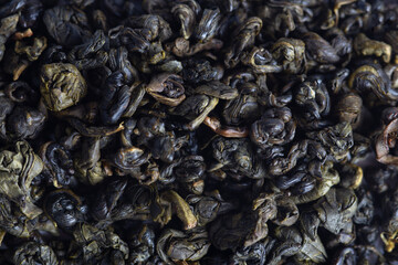 Natural dried green tea leaves, backdrop.